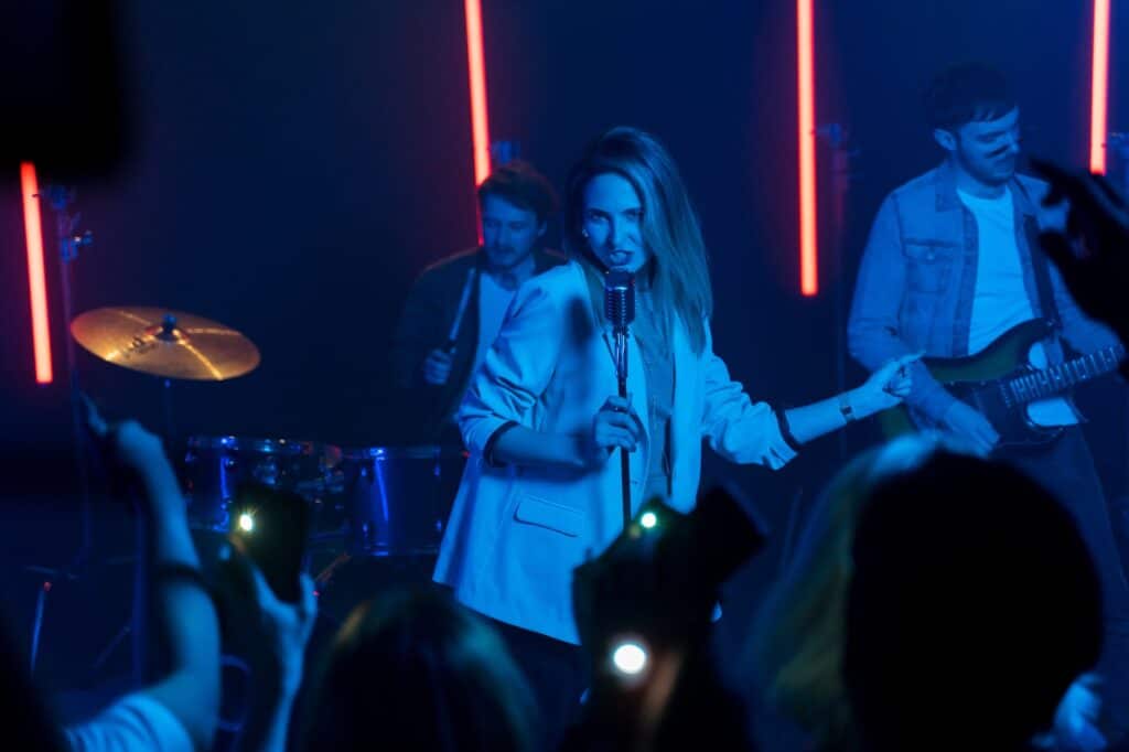 a woman holding a microphone singing